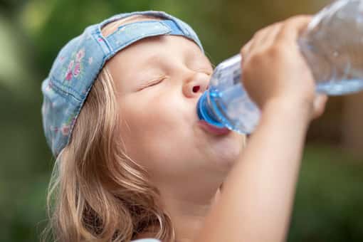 A child drinking from a water bottle