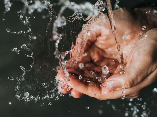 Cupped hands in water